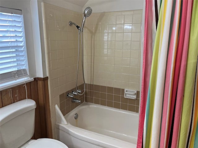 bathroom featuring shower / tub combo with curtain, wooden walls, and toilet