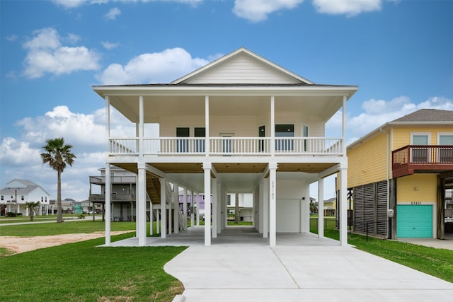 beach home with a carport, a porch, and a front yard