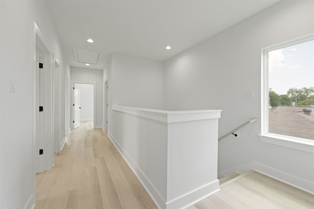 hallway with light hardwood / wood-style floors