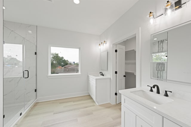 bathroom featuring vanity, a shower with shower door, and hardwood / wood-style flooring