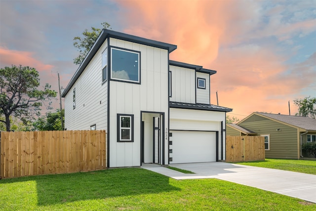 view of front of house with a garage and a lawn