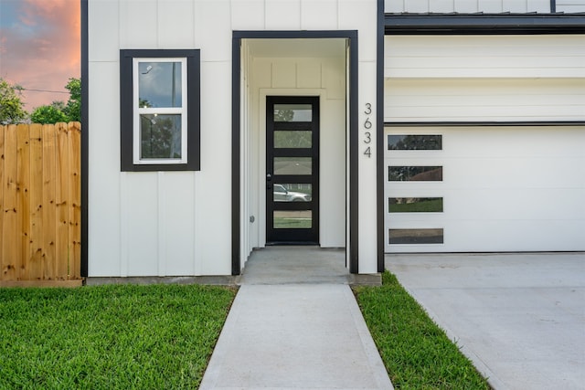 exterior entry at dusk with a garage