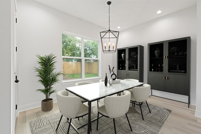 dining space featuring a notable chandelier, light hardwood / wood-style floors, and plenty of natural light