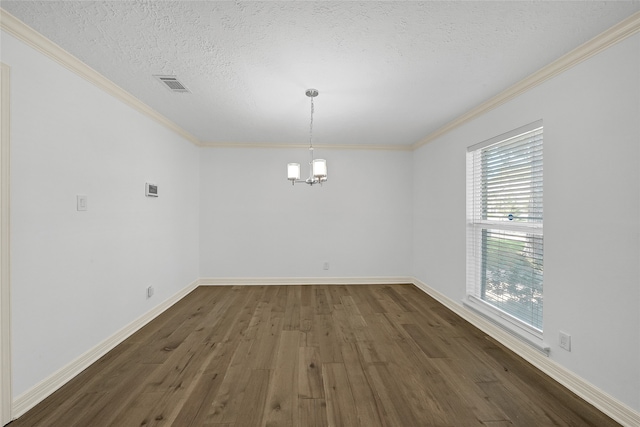 unfurnished dining area with a notable chandelier, dark hardwood / wood-style floors, ornamental molding, and a textured ceiling