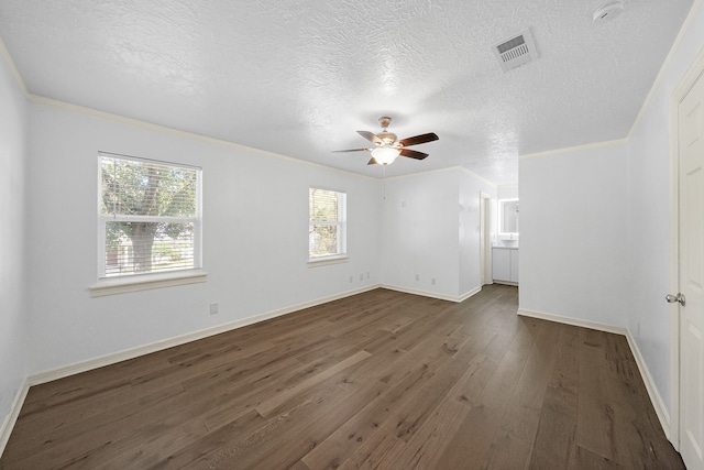 empty room with a textured ceiling, dark hardwood / wood-style floors, ceiling fan, and crown molding