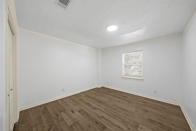 unfurnished room featuring crown molding, dark hardwood / wood-style flooring, and a textured ceiling