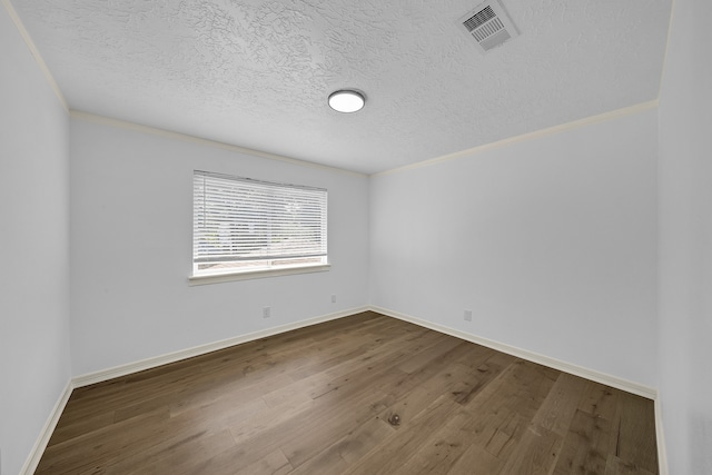 unfurnished room with wood-type flooring, a textured ceiling, and crown molding