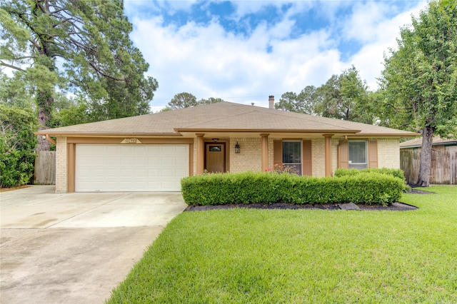 ranch-style house featuring a garage and a front lawn