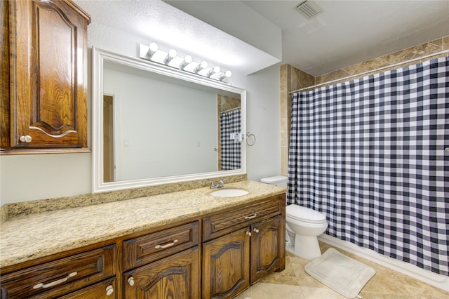 bathroom featuring tile patterned floors, walk in shower, vanity, and toilet