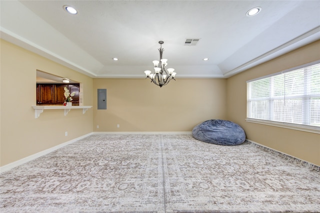 unfurnished room featuring an inviting chandelier, carpet, a tray ceiling, and electric panel