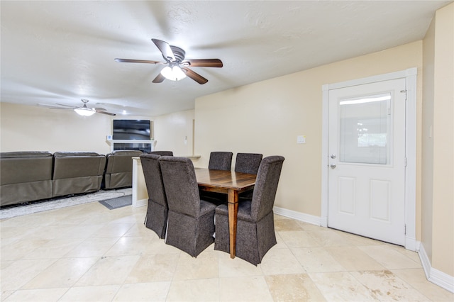 dining area with ceiling fan and light tile patterned floors