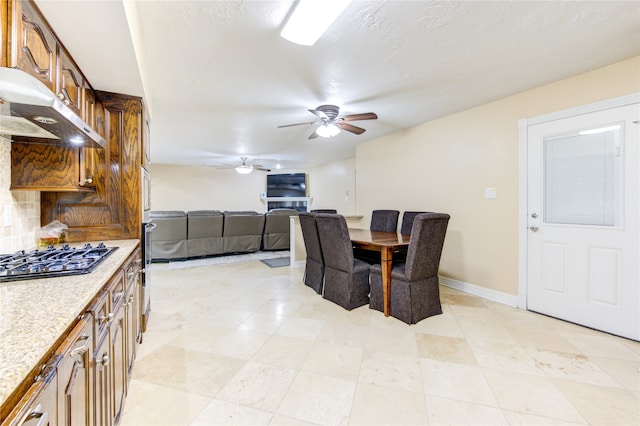 interior space featuring stainless steel gas stovetop and ceiling fan