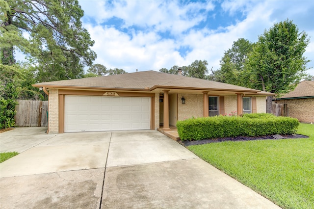 ranch-style home with a garage and a front yard