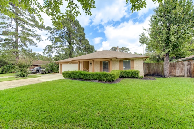 single story home featuring a garage and a front lawn