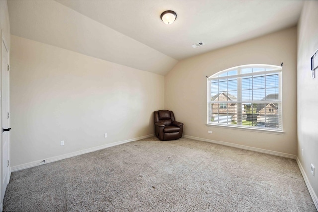 interior space featuring carpet and lofted ceiling