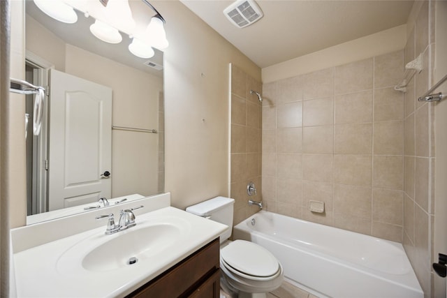 full bathroom featuring toilet, tiled shower / bath combo, and vanity