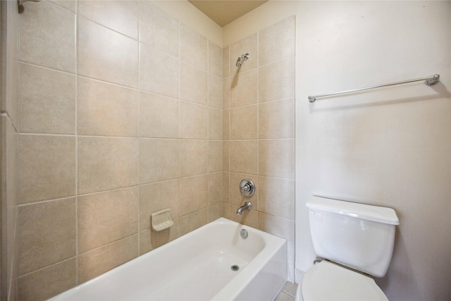 bathroom with toilet and tiled shower / bath combo