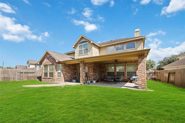 rear view of property with a patio area and a lawn