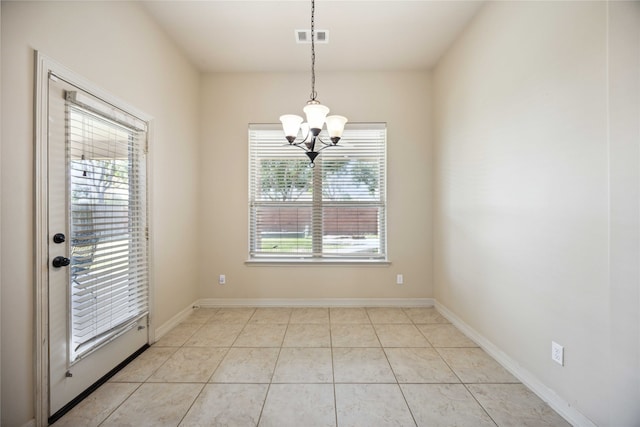 unfurnished dining area featuring a healthy amount of sunlight, light tile patterned floors, and an inviting chandelier