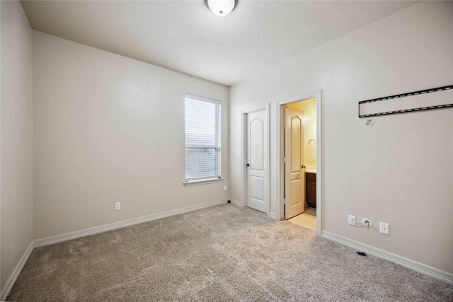 unfurnished room with light colored carpet