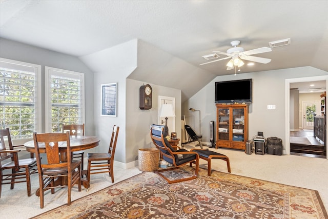 carpeted dining room featuring lofted ceiling and ceiling fan