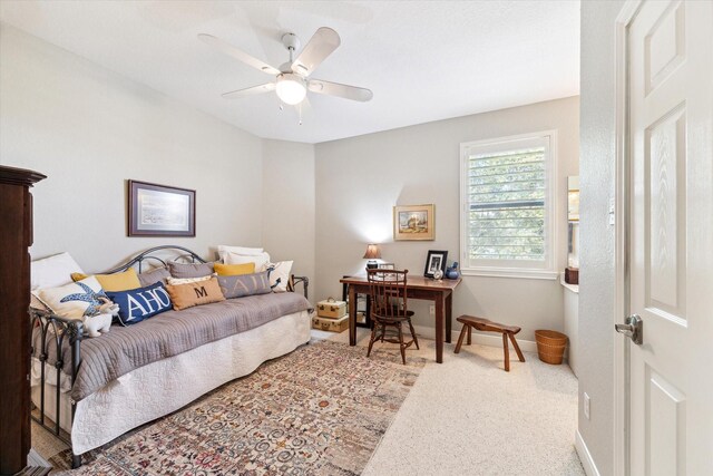 bedroom featuring ceiling fan and carpet