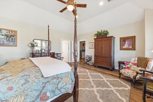 bedroom with vaulted ceiling, a closet, hardwood / wood-style floors, and ceiling fan