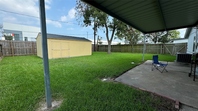 view of yard with central AC unit, a patio area, and a shed