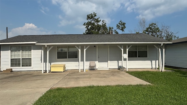 single story home with a front yard and a patio area