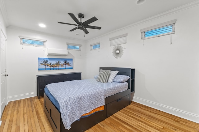 bedroom featuring a wall mounted air conditioner, ceiling fan, light hardwood / wood-style floors, and ornamental molding