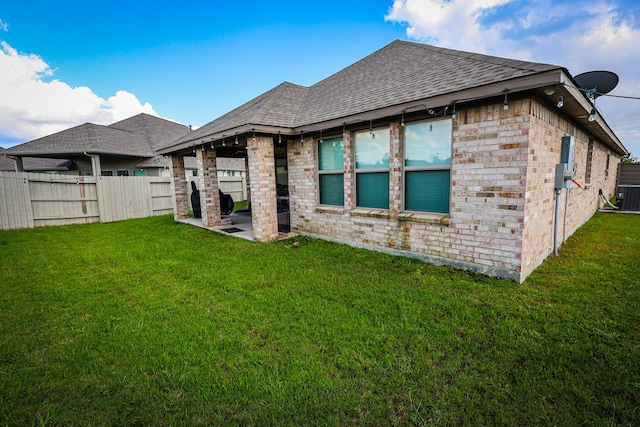 back of house featuring a patio and a yard