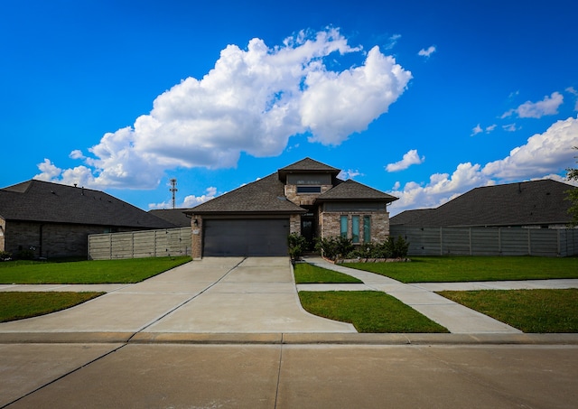 view of front of home featuring a front lawn and a garage