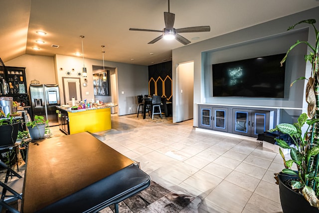 living room featuring ceiling fan, lofted ceiling, and light tile patterned floors