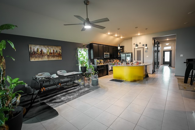 kitchen featuring dark brown cabinets, light tile patterned flooring, lofted ceiling, stainless steel appliances, and ceiling fan