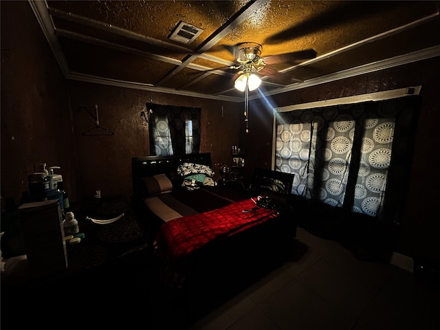 bedroom with a textured ceiling, ornamental molding, and ceiling fan