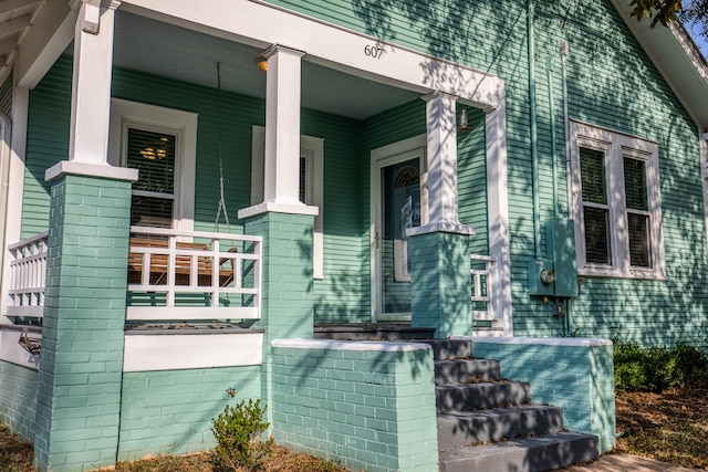 view of side of home with a porch