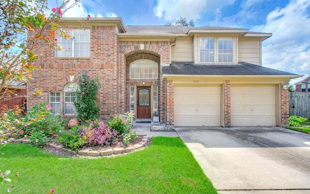 view of front facade featuring a front yard and a garage