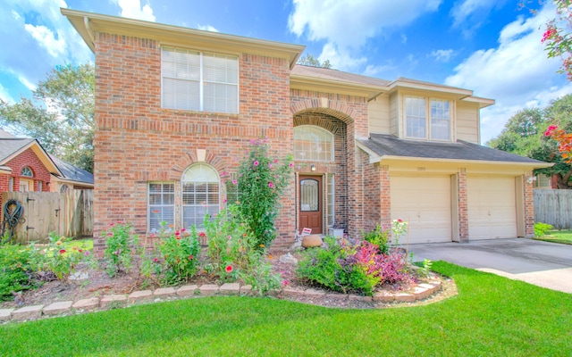 view of front of house featuring a front yard and a garage