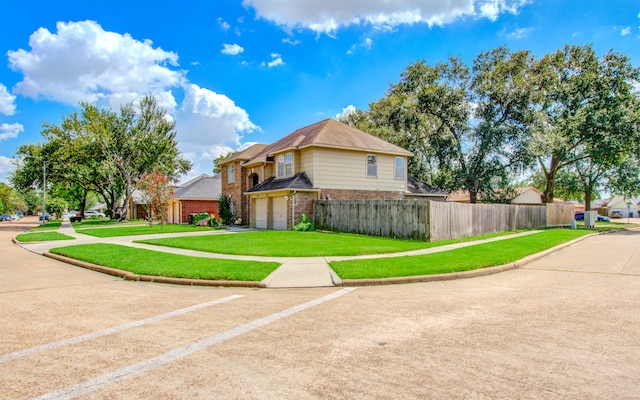 view of front of home featuring a front yard and a garage