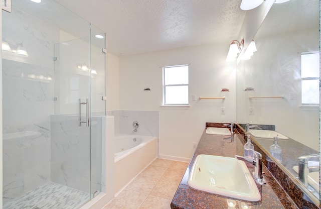 bathroom with ceiling fan, vanity, a textured ceiling, tile patterned floors, and shower with separate bathtub