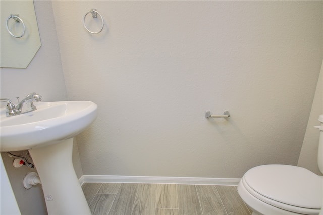 bathroom featuring toilet and hardwood / wood-style flooring