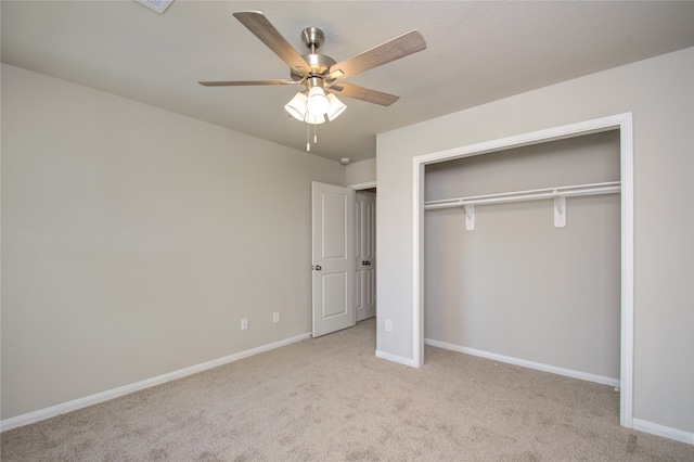 unfurnished bedroom featuring ceiling fan, light colored carpet, and a closet