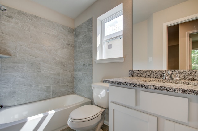 full bathroom featuring vanity, tiled shower / bath combo, toilet, and a healthy amount of sunlight