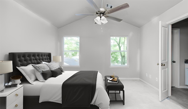 bedroom with vaulted ceiling, ceiling fan, and multiple windows