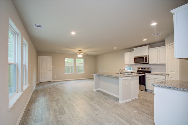 kitchen featuring white cabinetry, stainless steel appliances, ceiling fan, light hardwood / wood-style flooring, and a kitchen island with sink