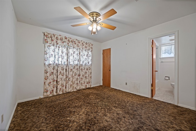 empty room featuring carpet floors and ceiling fan