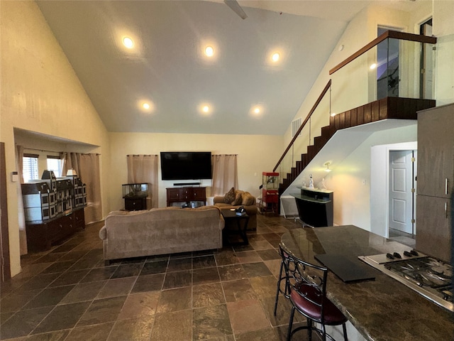 living room featuring high vaulted ceiling