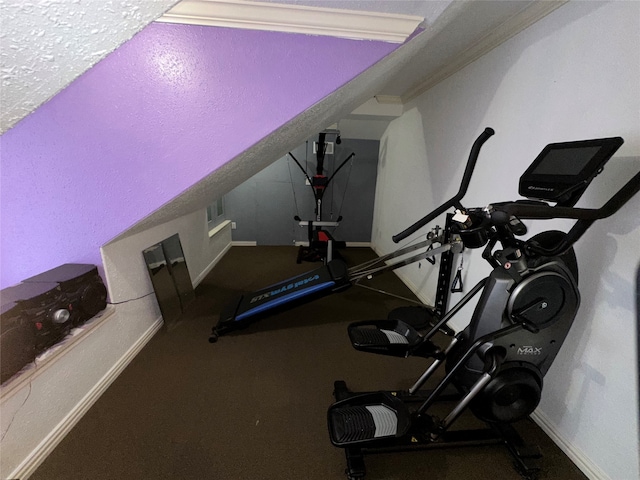 workout room featuring crown molding