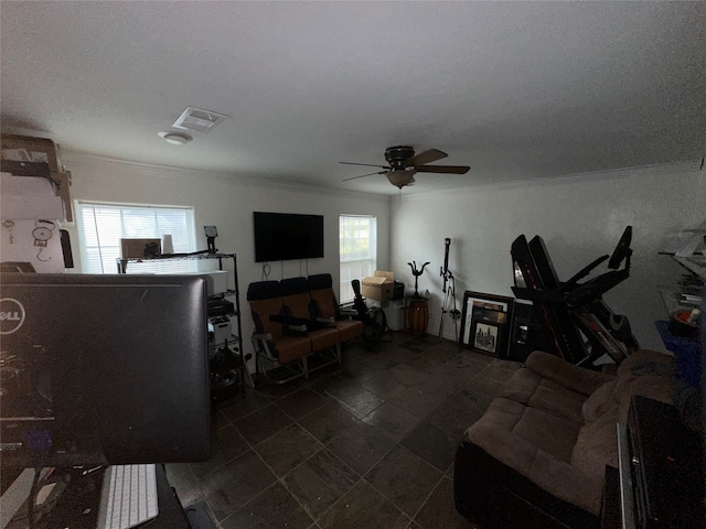 living room featuring a healthy amount of sunlight, crown molding, and ceiling fan