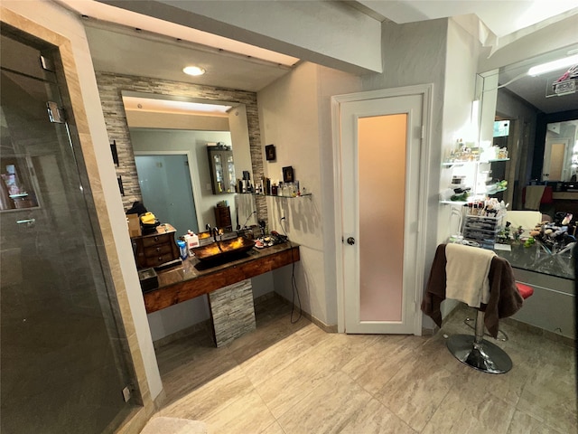 bathroom with walk in shower and sink